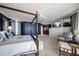 Spacious main bedroom with a four-poster bed and built-in entertainment center at 3 Seaside Ln # 601, Belleair, FL 33756