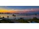 Scenic sunset over calm water with palm trees at 3 Seaside Ln # 601, Belleair, FL 33756