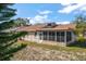 Home features a large backyard with screened-in porch at 3954 Sailmaker Ln, Holiday, FL 34691