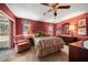 Bedroom with a queen-sized bed, an armchair, and a view of the backyard at 3954 Sailmaker Ln, Holiday, FL 34691