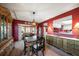 Dining area with a dark wood table and access to the kitchen at 3954 Sailmaker Ln, Holiday, FL 34691