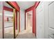 Hallway with mirrored closet doors and access to bathroom and bedroom at 3954 Sailmaker Ln, Holiday, FL 34691