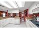 Bright kitchen features white cabinets, granite counters, and stainless steel appliances at 3954 Sailmaker Ln, Holiday, FL 34691