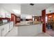 Open kitchen with white cabinets, granite counters, and breakfast bar at 3954 Sailmaker Ln, Holiday, FL 34691