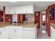 This kitchen features white cabinets, granite countertops, and a double sink at 3954 Sailmaker Ln, Holiday, FL 34691