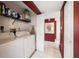 White laundry room with washer, dryer, and shelving at 3954 Sailmaker Ln, Holiday, FL 34691