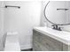 Modern bathroom with a floating vanity and round mirror at 4511 Helena Ne St, St Petersburg, FL 33703