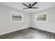 Renovated bedroom with gray vinyl flooring and ceiling fan at 4511 Helena Ne St, St Petersburg, FL 33703