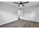 Bedroom with new flooring, ceiling fan, and sliding doors at 4511 Helena Ne St, St Petersburg, FL 33703