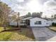 Newly renovated home with modern facade, landscaping, and driveway at 4511 Helena Ne St, St Petersburg, FL 33703