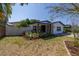 Landscaped front yard with covered patio and seating area at 4511 Helena Ne St, St Petersburg, FL 33703