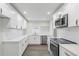 Modern white kitchen with stainless steel appliances at 4511 Helena Ne St, St Petersburg, FL 33703