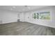 Bright living room with gray vinyl plank flooring at 4511 Helena Ne St, St Petersburg, FL 33703