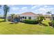 Well-manicured backyard featuring a private screened pool and lush landscaping at 5556 Sabal Trace Dr, North Port, FL 34287
