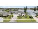 Aerial view of the home highlighting its landscaped yard and water views at 5556 Sabal Trace Dr, North Port, FL 34287