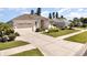 Charming single-Gathering home featuring a two-car garage, manicured landscaping, and a welcoming entrance at 5556 Sabal Trace Dr, North Port, FL 34287