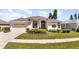 Well-maintained home featuring a manicured front lawn and inviting curb appeal at 5556 Sabal Trace Dr, North Port, FL 34287