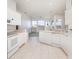 Spacious, bright kitchen with white cabinets, modern appliances, and a seamless transition to the living area at 5556 Sabal Trace Dr, North Port, FL 34287