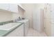 Functional laundry room with ample storage, sink and machines at 5556 Sabal Trace Dr, North Port, FL 34287