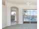 Bright room with views of the pool and lake from large sliding glass doors at 5556 Sabal Trace Dr, North Port, FL 34287