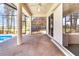 Covered patio with brick flooring and views of the pool and surrounding water features at 5556 Sabal Trace Dr, North Port, FL 34287