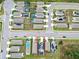 An aerial view of a residential neighborhood with a focus on a home with a backyard pool and solar panels at 5808 Calla Lilly Dr, Sarasota, FL 34232