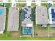 Aerial view of a neighborhood highlighting a home with solar panels and a screened-in pool at 5808 Calla Lilly Dr, Sarasota, FL 34232