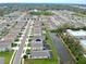 Expansive aerial view of a residential neighborhood featuring numerous homes, water features, and manicured landscaping at 5808 Calla Lilly Dr, Sarasota, FL 34232