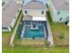 Backyard featuring a screened-in pool and spa, complemented by a black metal fence for privacy and security at 5808 Calla Lilly Dr, Sarasota, FL 34232