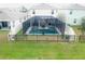 Private backyard with a screened-in pool and spa, surrounded by a black metal fence for added security at 5808 Calla Lilly Dr, Sarasota, FL 34232