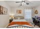 Comfortable bedroom with a queen-size bed, a built-in workspace, and modern art at 5808 Calla Lilly Dr, Sarasota, FL 34232