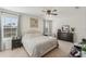 Bright bedroom with a king-size bed, dresser, and ceiling fan at 5808 Calla Lilly Dr, Sarasota, FL 34232