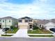 Charming two-story home features a manicured lawn, two-car garage, inviting entrance, and energy-efficient solar panels at 5808 Calla Lilly Dr, Sarasota, FL 34232