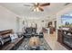Open living room with leather furniture and a view of the kitchen at 5808 Calla Lilly Dr, Sarasota, FL 34232