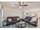 Spacious living room with comfortable leather furniture and ceiling fan at 5808 Calla Lilly Dr, Sarasota, FL 34232