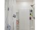 Shower with built-in shelves and curtain at 5808 Calla Lilly Dr, Sarasota, FL 34232