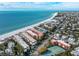 Aerial view showcasing beachfront property, ocean, and nearby town at 6006 Gulf Dr # 207, Holmes Beach, FL 34217