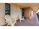 Covered balcony with two chairs, near entrance at 6006 Gulf Dr # 207, Holmes Beach, FL 34217