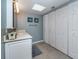 White vanity, tile floor, and linen closet in bathroom at 6006 Gulf Dr # 207, Holmes Beach, FL 34217