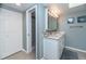 Bathroom with a white vanity, large mirror, and tile floor at 6006 Gulf Dr # 207, Holmes Beach, FL 34217