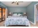 King bed, balcony access, coastal decor, and ceiling fan at 6006 Gulf Dr # 207, Holmes Beach, FL 34217