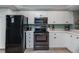 Kitchen with black refrigerator and stainless steel appliances at 6006 Gulf Dr # 207, Holmes Beach, FL 34217