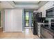 White kitchen cabinets and black appliances with balcony view at 6006 Gulf Dr # 207, Holmes Beach, FL 34217