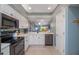 Modern kitchen with stainless steel appliances and white cabinets at 6006 Gulf Dr # 207, Holmes Beach, FL 34217