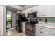 Kitchen with black appliances and white cabinets at 6006 Gulf Dr # 207, Holmes Beach, FL 34217