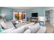 Spacious living room with sectional sofa and access to a balcony at 6006 Gulf Dr # 207, Holmes Beach, FL 34217