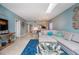 Open living room with sectional sofa and TV at 6006 Gulf Dr # 207, Holmes Beach, FL 34217