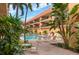 Relaxing pool area with lounge chairs, surrounded by tropical foliage at 6006 Gulf Dr # 207, Holmes Beach, FL 34217