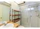 Bathroom with tiled shower, vanity with double sinks, and wooden countertop at 7853 Sundown Dr, St Petersburg, FL 33709