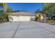 Three-car garage and driveway of a single Gathering home at 10079 Deer St, Spring Hill, FL 34608